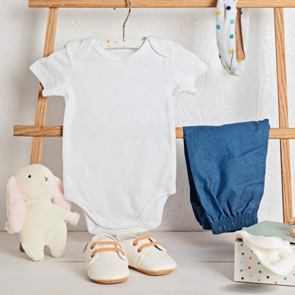 The Essential Onesie by At Ease Baby in soft white organic cotton, showing the tagless design